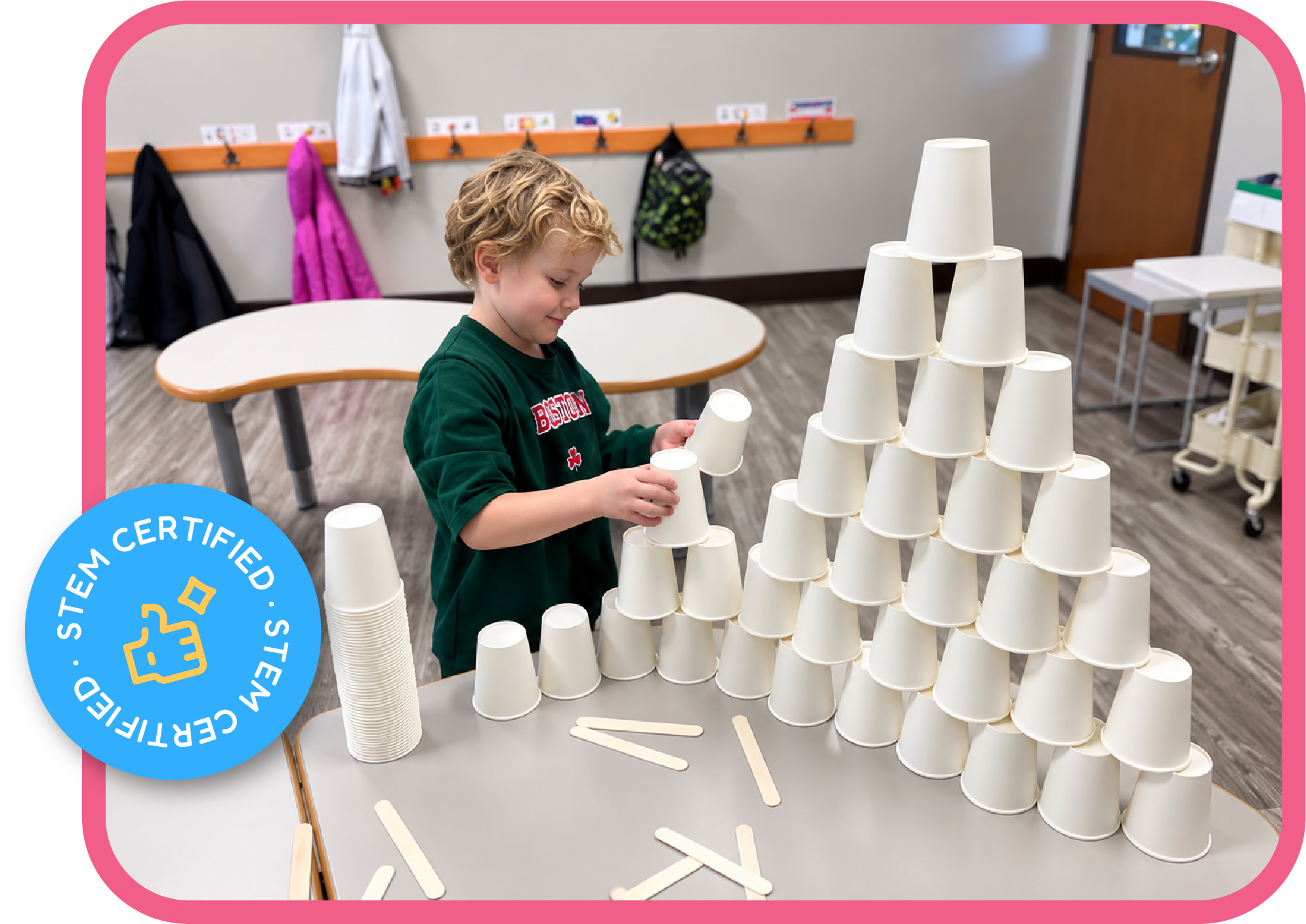 Child building a cup pyramid, a STEM engineering activity at STEM Bright Beginnings daycare in Leander, TX