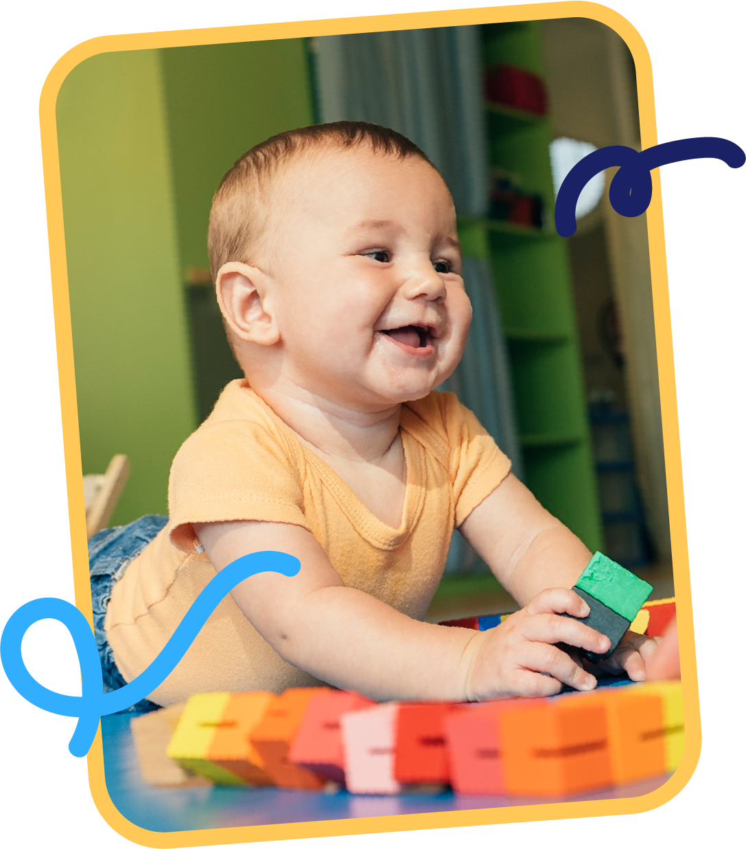 Smiling infant reaching for colorful wooden blocks during sensory play in the Discoverers program at STEM Bright Beginnings in Leander, TX