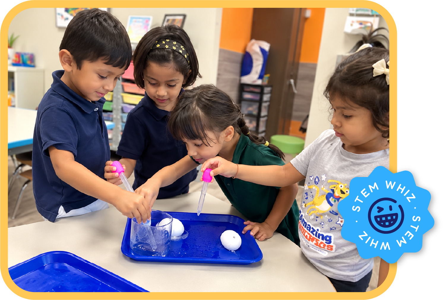 Young children conducting a hands-on STEM experiment with color droppers and water at STEM Bright Beginnings childcare and daycare in Leander, TX