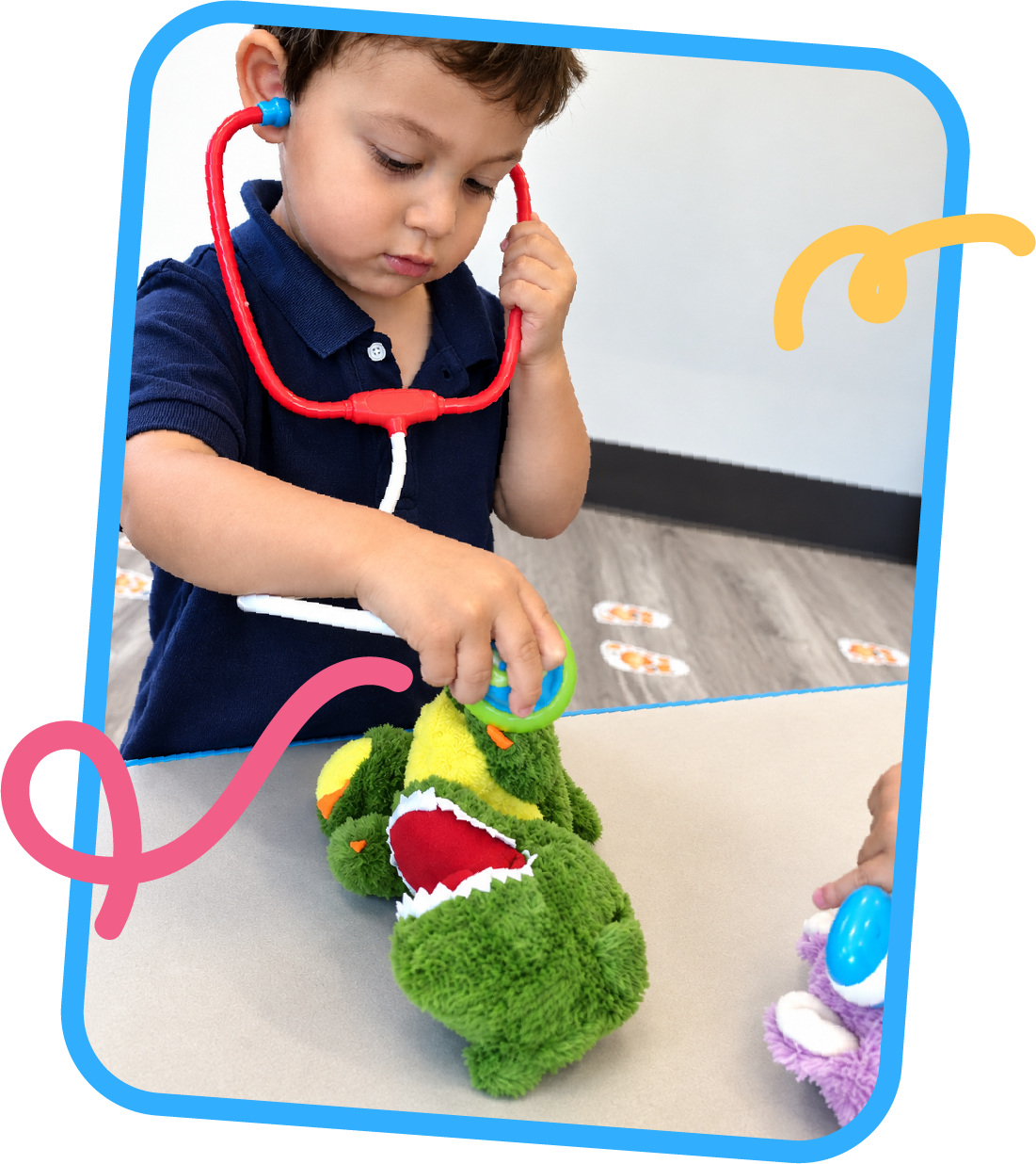 Young boy listening through a toy stethoscope while examining a stuffed dinosaur during pretend play at STEM Bright Beginnings in Leander, TX