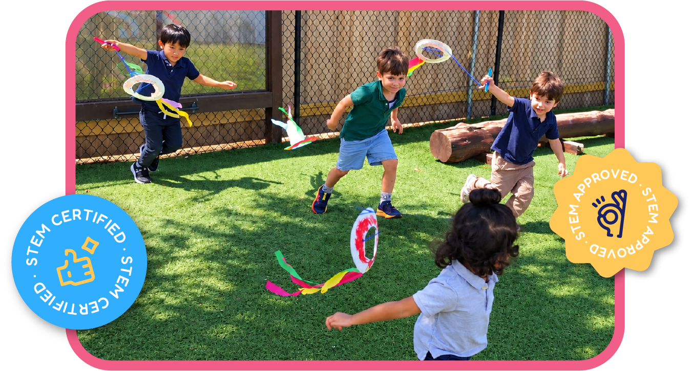 Children playing outdoors with colorful DIY wind streamers, exploring motion and physics at STEM Bright Beginnings childcare and daycare in Leander, TX