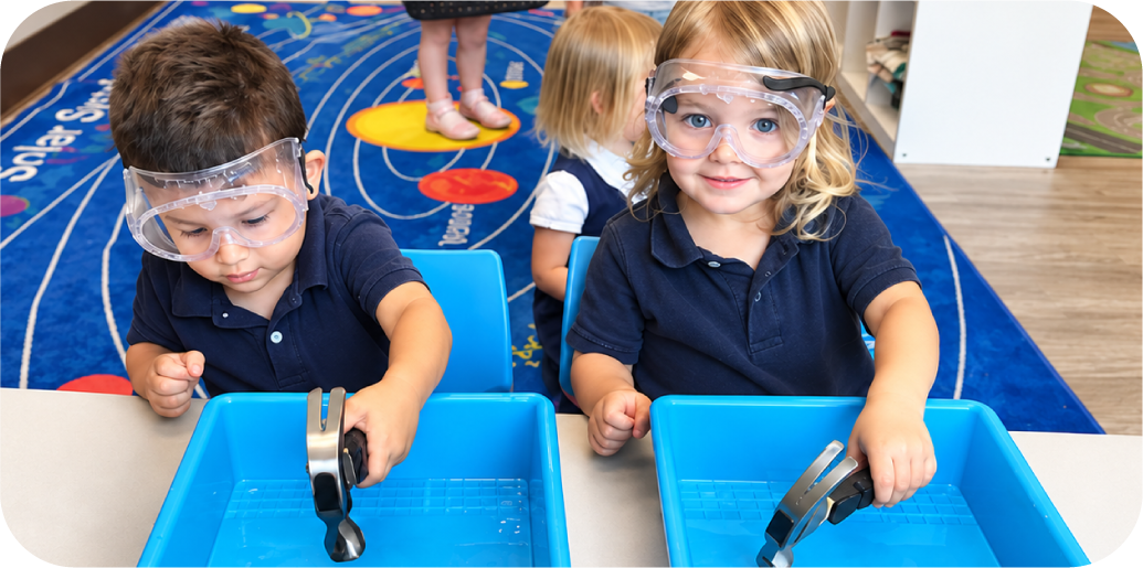 Toddlers wearing safety goggles doing a STEM water experiment at STEM Bright Beginnings daycare in Leander, TX