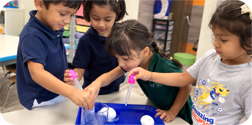 Young children conducting a hands-on STEM experiment with color droppers and water at STEM Bright Beginnings childcare and daycare in Leander, TX